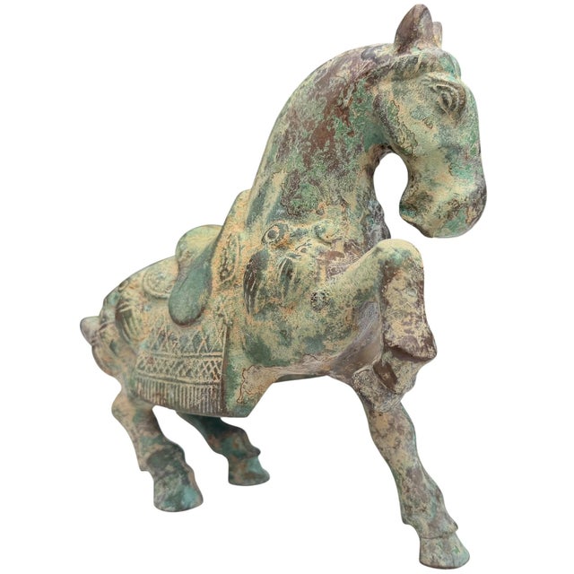 A substantial vintage cast bronze horse sculpture featuring a richly developed natural verdigris patina and bold,...