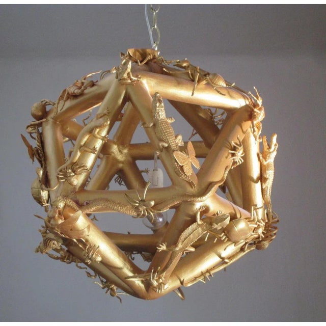 Absolutely charming and One-of-a-kind ceiling light in form of a polyhedron decorated with several reptiles and...