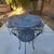 Vintage French bronze outdoor patio table & 4 arm chairs. Great patina. Measurements: Table Height 29" Table Diameter 47",...