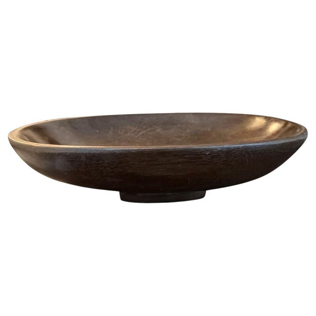 A beautiful oval bowl is hand carved from a single piece of Merbau wood. Circa 1950 One of a kind bowl sourced in the...