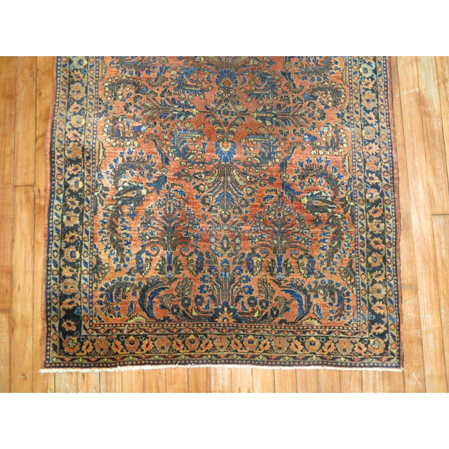 An early 20th century classic Persian Sarouk rug in copper, blue and brown . Measures: 3'3'' x 4'9”.