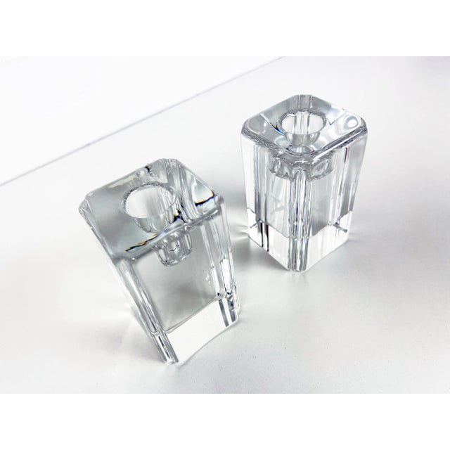 Two tall block-style candle holders in clear crystal, signed Kosta and Ehrner underneath on the bases. Each base is...