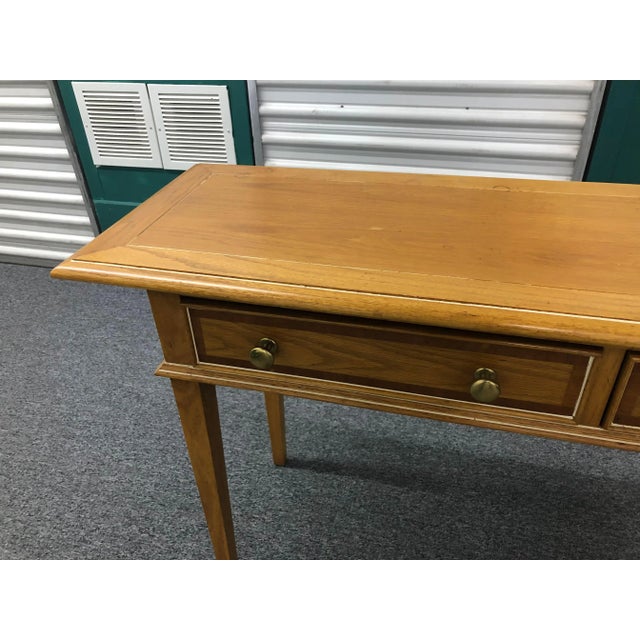 Long console table made by Century Fine Furniture. Oak with white accents and brass knobs. Three drawers.