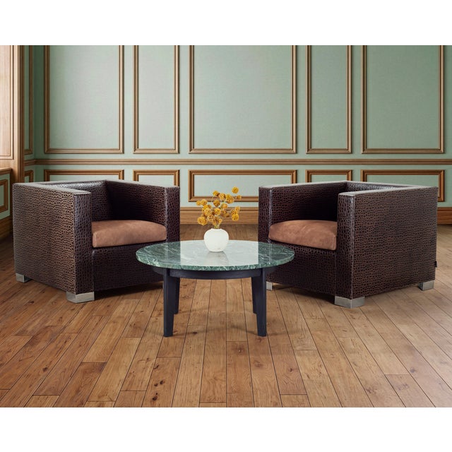 A sleek mid-century modern coffee or cocktail table crafted from a bold slab of Italian Verde Antico marble atop a carved...