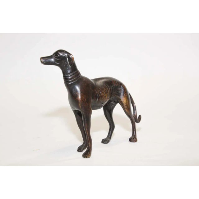 Beautiful cast metal bronze greyhound dog sculpture. An elegant, detailed cast sculpture depicting a greyhound dog.....