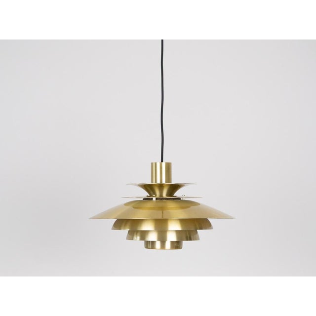 This lamp was designed by Danish designer Kurt Wiborg and manufactured by Jeka. The lamp's form is based on the principle...
