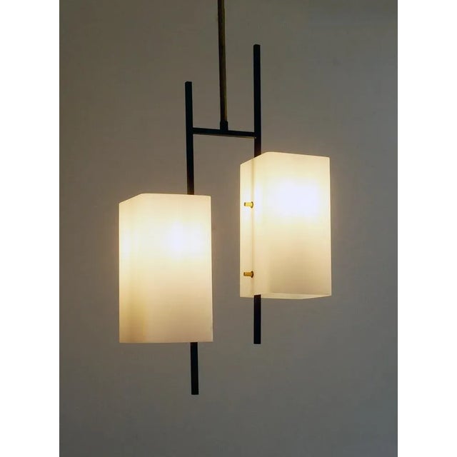 Attractive 1970 pendant lamp in opaline glass, brass, and black-painted metal. European Plug (up to 250V).The wiring of...