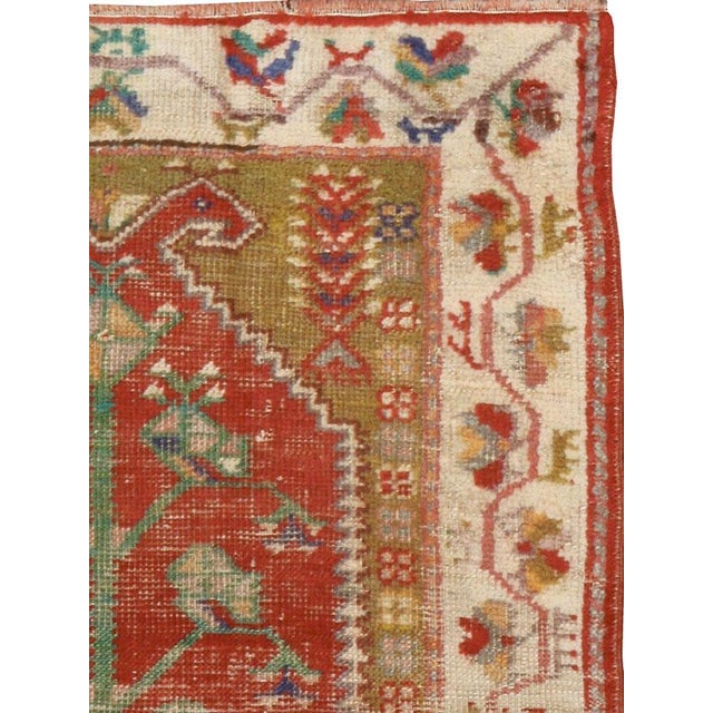 An antique Turkish Oushak rug from the early 20th century with a distressed appeal, but in strong and durable condition....