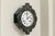A French Napoleon III wall clock with a lacquered wooden case with inlaid floral decorations surrounding a white enamel...