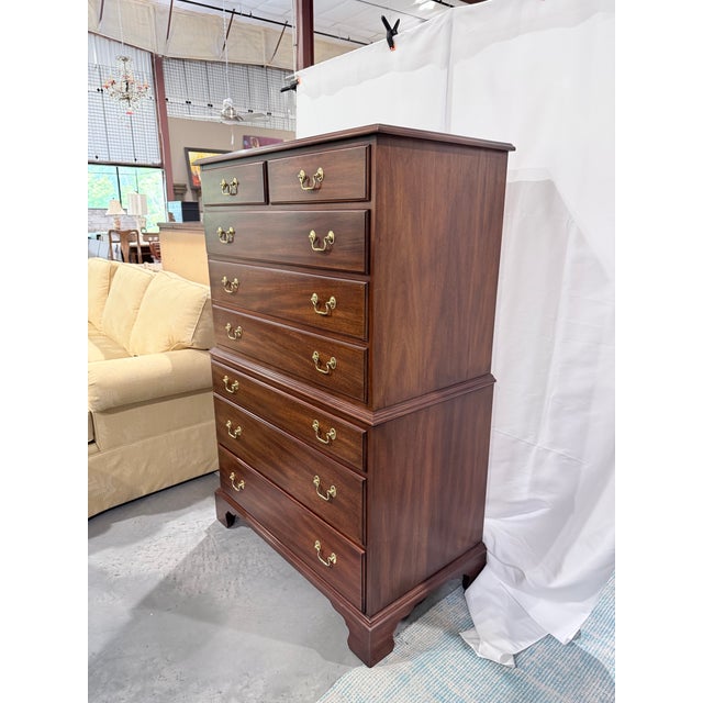A stately Henkel Harris chest on chest crafted in richly figured solid mahogany with timeless Chippendale-inspired styling...