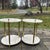 Pair 2 tier white marble top side tables. Brass finials, feet and fluted legs.