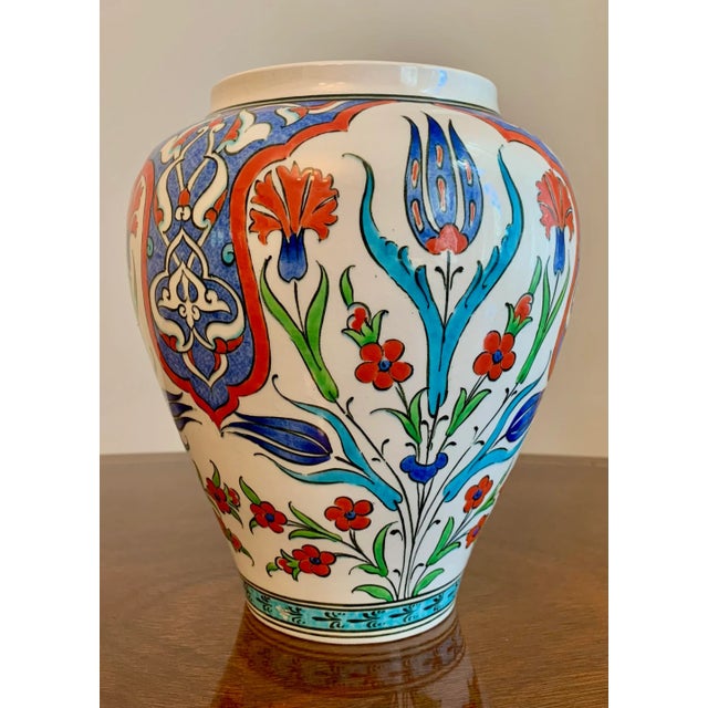 Beautifully handprinted Turkish urn with stylized flowers. Vibrant colors will brighten up a shelf. Place by your door to...