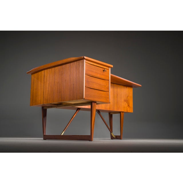 Iconic boomerang desk designed by peter løvig nielsen in the 1960s, crafted in teak with the sculptural asymmetry and...