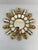 A splendid hand carved 12" French Giltwood Sunburst Wall Mirror, circa 1950s-60s. The central 3.5" flat mirror is framed...