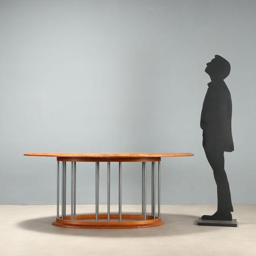 Oval table from the 1980s-1990s with an elegant top and a walnut wood base, perfect for those seeking furniture that...