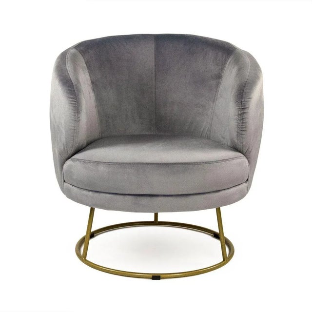 Spacious tub chair upholstered in white faux with circular bronze metal frame.