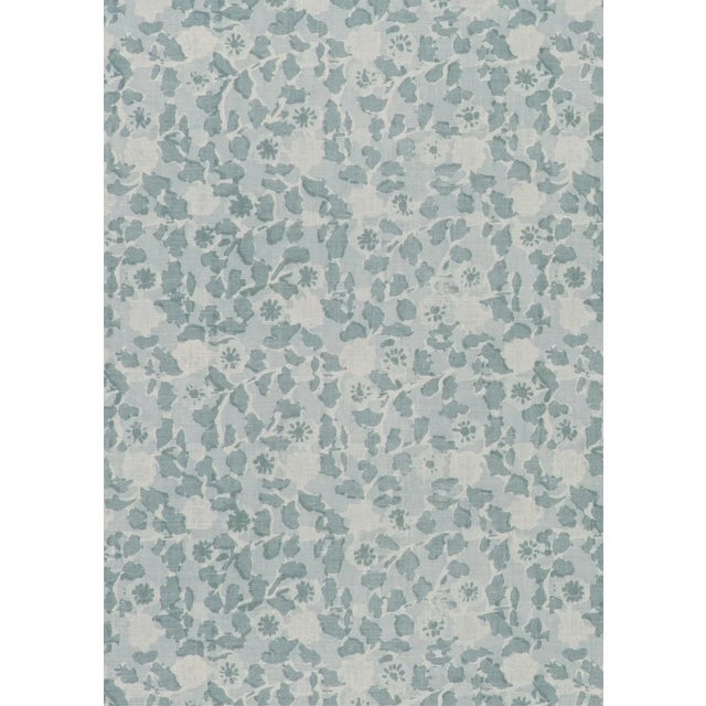 A painterly, blue-on-cream printed linen fabric remnant featuring an abstract floral. The remnant is 24" wide x 38" long....