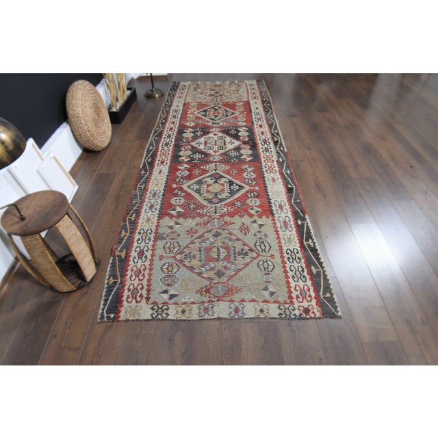 Vintage Hand-Knotted runner rug is a semi-antique vintage area rug. The '70s Eastern region of Anatolia's unique rug is...