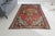 This is a vintage Turkish Oushak rug from the Mid 20th Century. The piece was hand-knotted.