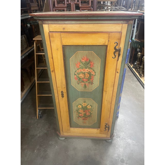 An early 19th century Scandinavian painted pine cupboard or armoire with a stepped cornice, single-door painted in sage...
