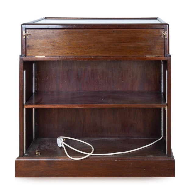 Antique early-20th Century mahogany and glass display cabinet. The cabinet features double doors with two glass shelves...