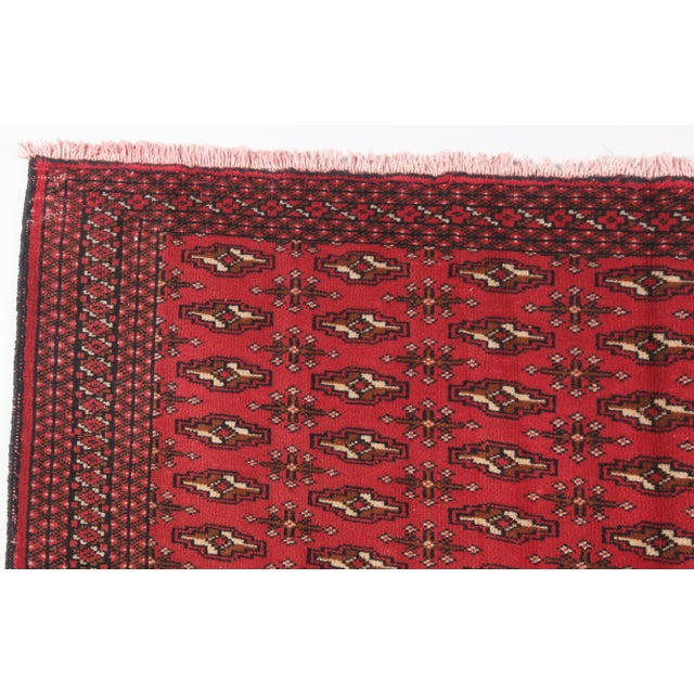 This vintage Turkoman rug is a fine example of Central Asian weaving traditions, crafted with a wool pile on a cotton...