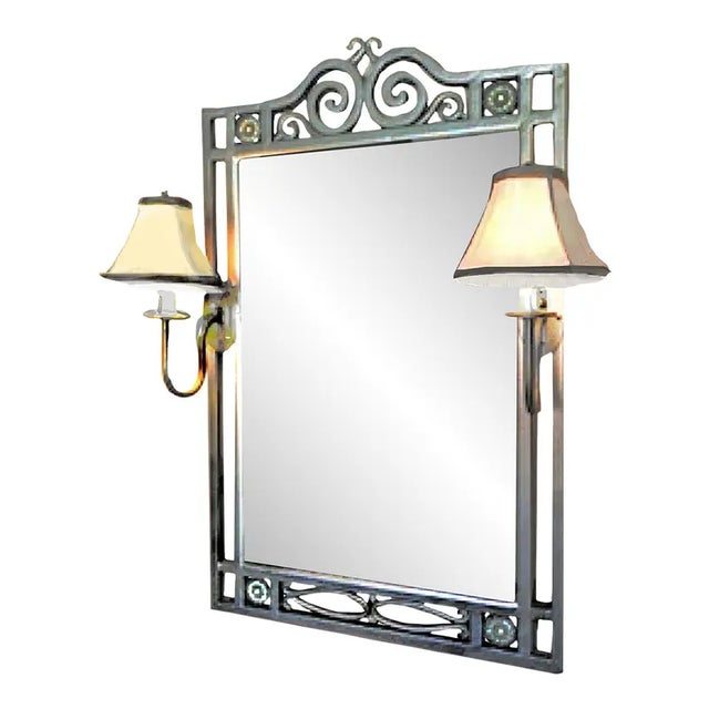 A wrought iron hand-welded frame surrounding a beveled wall mirror by Hampton Bay. It features a pair of permanently...