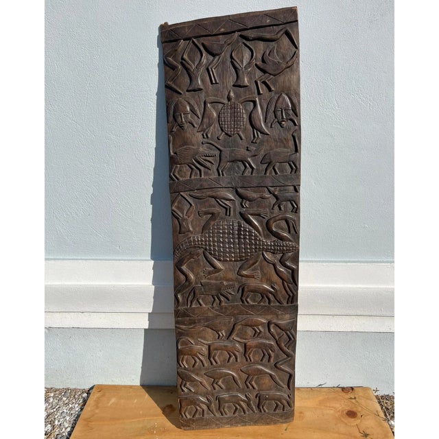 African Hand Carved Dogon Granary Door. Wooden door from Mali with hand carved images that represent the owner’s family...