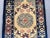 This vintage Chinese hand-knotted wool rug displays a refined Art Deco-inspired medallion design with a soft cream field...