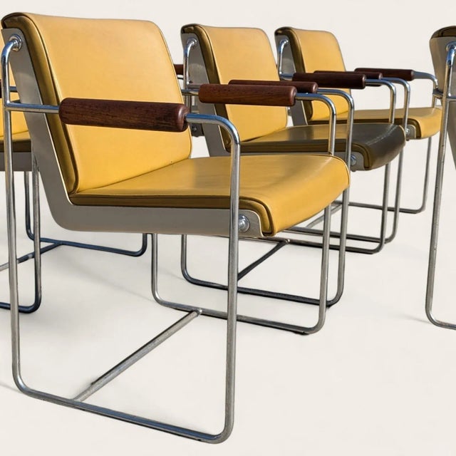 A rare suite of eight AFKA guest armchairs by Krueger Metal Products, circa 1969-1970, pairing mustard vinyl upholstery...