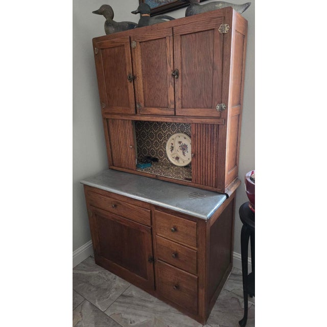 A exceptional early 20th-century solid oak Hoosier-style kitchen cabinet and hutch. Featuring authentic period...