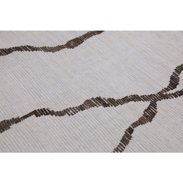 Introducing our exquisite handwoven wool modern Moroccan-style rug, a stunning blend of traditional craftsmanship and...