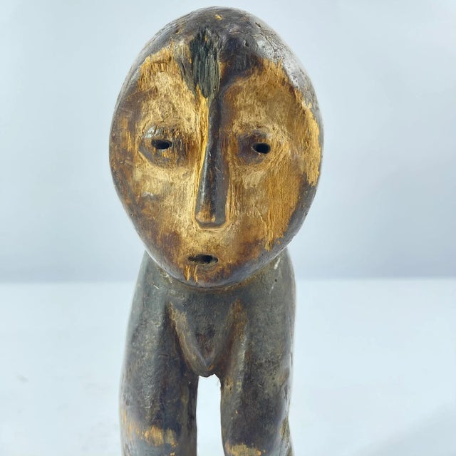 A hand-carved Lega figure originates from the Lega people in the Democratic Republic of the Congo. The figure is easily...