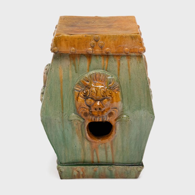 This low, ceramic garden drum is drip glazed in the manner of ancient Chinese sancai ware, cloaked in translucent shades...