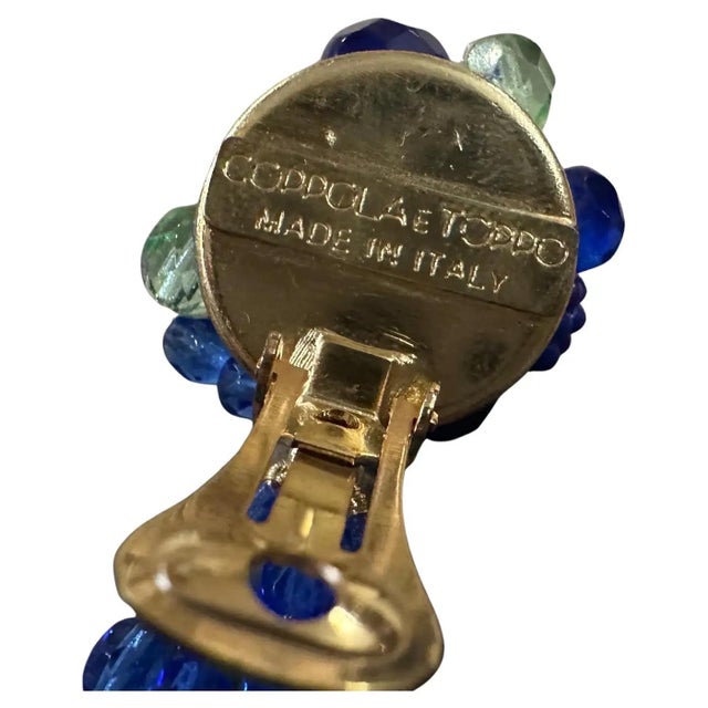 This pair of chandelier earrings is designed by Coppola e Toppo, renowned for their unique and intricate beadwork. The...