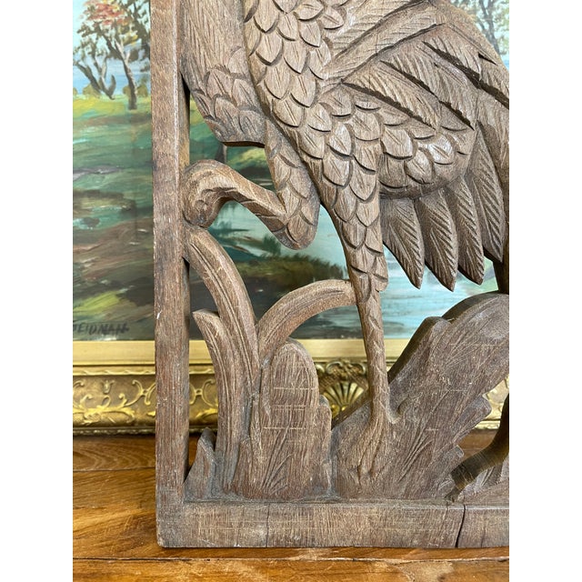 This vintage hand-carved wooden panel features a detailed depiction of a long-tailed bird surrounded by stylized foliage,...