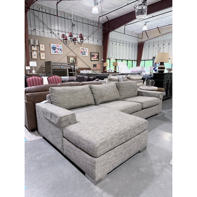 A sophisticated Ethan Allen Conway sectional sofa featuring a clean-lined contemporary silhouette and a spacious chaise...