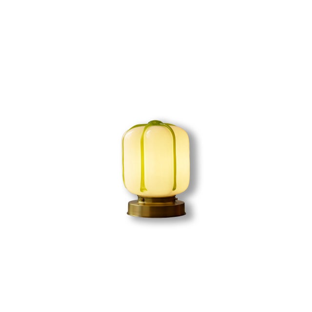 A compact wall or ceiling light defined by a soft, rounded silhouette and distinctive hand-shaped glass. The opaline...