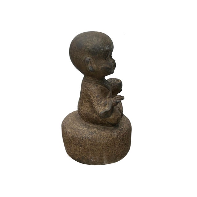 The Oriental Gray Stone Little Lohon Monk Playing GoChess Statue captures the serene essence of traditional Eastern...