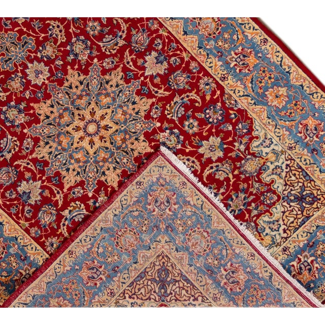 Beautiful vintage Persian Isfahan hand-knotted wool rug with a red field. This piece has a multi-color accent in an all-...
