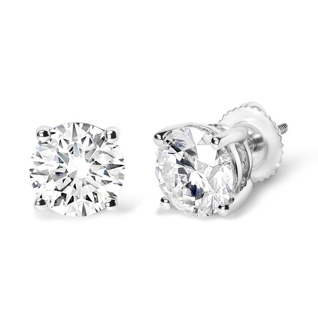 Discover the luminous splendor of these exquisite stud earrings, masterfully crafted from 14K white gold with a radiant...