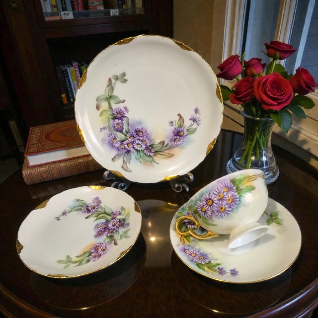 This R.C. Versailles Bavaria painted gilded purple Aster floral porcelain 4-piece tea set is a vintage piece originating...