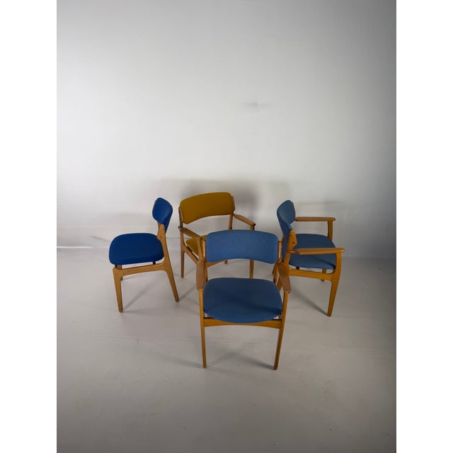 Set of four original chairs designed by Erik Buch, crafted from solid oak. The set consists of three armchairs – two...