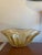 1970s Murano glass centerpiece/vase in "honey gold" tone. Characterized by a free, wavy form, it features a ribbed texture...