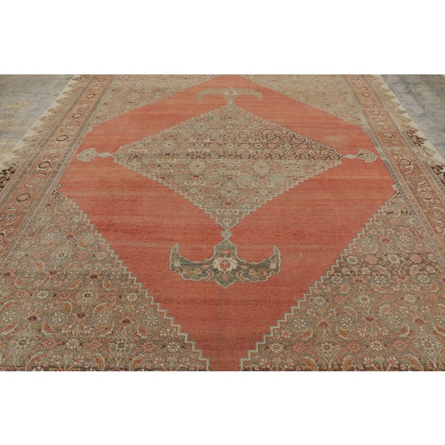 Hand-knotted in wool and originating circa 1910-1920, this 9x14 antique Persian Bidjar rug is a masterwork of early 20th-...