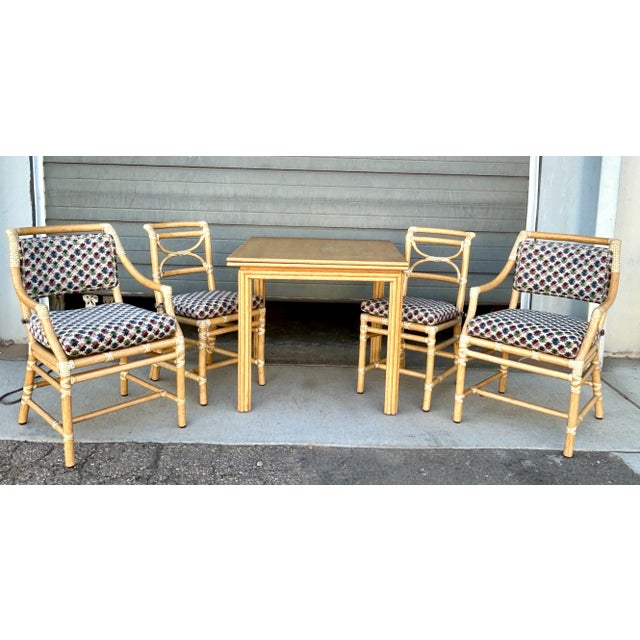 Exceptional vintage McGuire rattan games and dining set comprising a revolving flip-top table, two side chairs, and two...