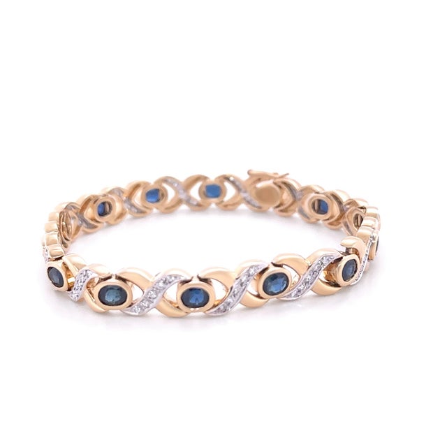 This exquisite bracelet is crafted in 14ct yellow gold with rhodium-plated settings, featuring a hand-assembled design...