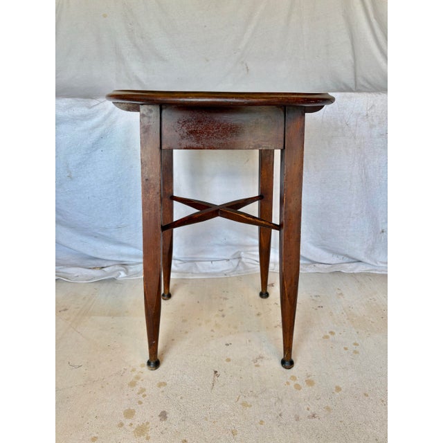 This 20th Century English Oak Tavern Side Table dates back to the early 1900's. The piece features a classic circular wood...