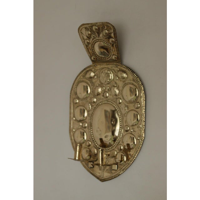 Made in Sweden A breath-taking mid-century duo of exquisite Swedish brass wall sconces, showcasing captivating hammered...