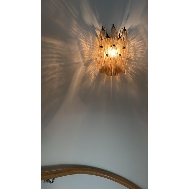 Eclectic beautiful stairwell murano wall lamp, consisting of 17 handmade crystal prisms in clear murano glass. Classic...